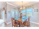 Cozy dining area with a wooden table, chandelier, and natural light from the windows at 3546 Flamingo Blvd, Hernando Beach, FL 34607