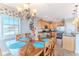Dining room with wooden table and chairs, chandelier, and view into the kitchen with stainless steel appliances at 3546 Flamingo Blvd, Hernando Beach, FL 34607
