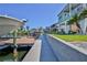 Canal-front home features a long patio, walkway, boat dock, and lush backyard lawn at 3546 Flamingo Blvd, Hernando Beach, FL 34607