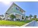 Charming elevated coastal home with lush lawn, columns, and a covered patio perfect for outdoor living at 3546 Flamingo Blvd, Hernando Beach, FL 34607