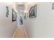 Hallway with neutral walls and carpet, adorned with decorative wall art leading to other areas of the home at 3546 Flamingo Blvd, Hernando Beach, FL 34607