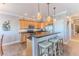 Well-lit kitchen featuring a breakfast bar, stainless steel appliances, and tile flooring at 3546 Flamingo Blvd, Hernando Beach, FL 34607
