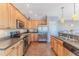 Modern kitchen with stainless steel appliances, ample cabinet space, and tile flooring at 3546 Flamingo Blvd, Hernando Beach, FL 34607