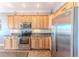 Bright kitchen showcasing stainless steel appliances, wooden cabinets, and tile floors at 3546 Flamingo Blvd, Hernando Beach, FL 34607