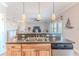 Open concept kitchen with breakfast bar, pendant lights, and seamless flow into the living area at 3546 Flamingo Blvd, Hernando Beach, FL 34607