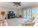 Comfortable living room featuring a large sofa, entertainment center, and scenic balcony access at 3546 Flamingo Blvd, Hernando Beach, FL 34607