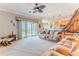 Inviting living room with a ceiling fan, large sofa, and sliding glass doors to the balcony at 3546 Flamingo Blvd, Hernando Beach, FL 34607