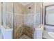 The bathroom features a glass door shower with neutral-colored tile and a decorative tiled stripe at 3546 Flamingo Blvd, Hernando Beach, FL 34607