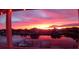 Stunning sunset view from the porch overlooking the canal with boats docked and a vibrant sky at 3546 Flamingo Blvd, Hernando Beach, FL 34607
