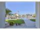 Stunning waterfront view featuring a boat lift, dock, and beautiful landscaping from the home's vantage point at 3546 Flamingo Blvd, Hernando Beach, FL 34607