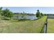 Spacious backyard with a view of the picturesque lake and surrounding greenery at 3767 Dragonfly Trl, Odessa, FL 33556