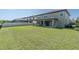 Large backyard with a covered patio and view of the neighboring homes at 3767 Dragonfly Trl, Odessa, FL 33556