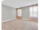 Neutral bedroom with plush carpet, sheer curtains, and bright natural light from dual windows at 3767 Dragonfly Trl, Odessa, FL 33556