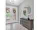 Elegant entryway with stylish console table, decorative mirror, and grand double doors with decorative glass at 3767 Dragonfly Trl, Odessa, FL 33556
