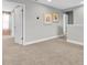 Upstairs hallway featuring neutral carpet, a door to a bedroom and modern decorations at 3767 Dragonfly Trl, Odessa, FL 33556