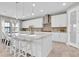 Eat-in kitchen with a large central island, bar stool seating, stylish pendant lighting, and updated appliances at 3767 Dragonfly Trl, Odessa, FL 33556