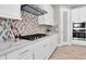 Modern kitchen features white cabinets, quartz countertops, tile backsplash, and stainless steel appliances at 3767 Dragonfly Trl, Odessa, FL 33556