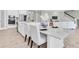 Open-concept kitchen with large island featuring white countertops, modern appliances, and adjacent dining area at 3767 Dragonfly Trl, Odessa, FL 33556