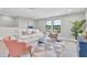 Comfortable living room featuring a stylish geometric rug, plush seating, and sun-filled windows at 3767 Dragonfly Trl, Odessa, FL 33556