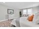 Relaxing main bedroom featuring a dresser, plants, and decorative pillows in a bright, airy space at 3767 Dragonfly Trl, Odessa, FL 33556