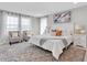 Comfortable main bedroom with a bed, chairs, and large windows, showcasing a serene retreat at 3767 Dragonfly Trl, Odessa, FL 33556