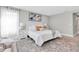 Inviting main bedroom features neutral tones, plush bedding, and a calming ambiance for relaxation at 3767 Dragonfly Trl, Odessa, FL 33556