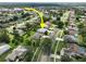 An aerial shot shows the home nestled in a residential neighborhood with mature trees at 4048 St Ives Blvd, Spring Hill, FL 34609