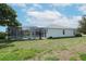 Private backyard featuring a screened-in pool and ample green space for relaxation and recreation at 4048 St Ives Blvd, Spring Hill, FL 34609