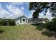 A spacious backyard with lush greenery and a screened-in pool, perfect for outdoor living and entertaining at 4048 St Ives Blvd, Spring Hill, FL 34609