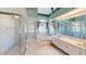 Well-lit bathroom features glass shower, tub, and double sink vanity at 4048 St Ives Blvd, Spring Hill, FL 34609
