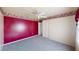 Cozy bedroom with carpet, ceiling fan, wallpaper border, and ample closet space at 4048 St Ives Blvd, Spring Hill, FL 34609