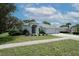 A charming single-Gathering home with a well-manicured lawn, mature trees, and a welcoming front entrance at 4048 St Ives Blvd, Spring Hill, FL 34609