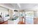 Kitchen featuring a bar area perfect for entertaining with sliding glass doors to the backyard at 4048 St Ives Blvd, Spring Hill, FL 34609