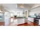 Eat-in kitchen featuring hardwood floors, stainless steel appliances, and access to the living area at 4048 St Ives Blvd, Spring Hill, FL 34609
