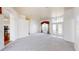 Spacious living room with neutral carpet, a chandelier, and double front doors at 4048 St Ives Blvd, Spring Hill, FL 34609