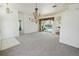 Bright living room with neutral carpet, chandelier and sliding doors to pool at 4048 St Ives Blvd, Spring Hill, FL 34609