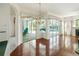 Open concept living space showcasing patio access to pool, hard wood floors, and modern finishes at 4048 St Ives Blvd, Spring Hill, FL 34609