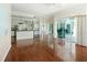 Open-concept living area featuring hardwood floors, kitchen and access to the backyard at 4048 St Ives Blvd, Spring Hill, FL 34609
