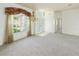 Bright living room with high ceilings, neutral carpet and a chandelier at 4048 St Ives Blvd, Spring Hill, FL 34609