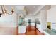 Open-concept living space with hardwood floors and stainless steel appliances in the kitchen at 4048 St Ives Blvd, Spring Hill, FL 34609