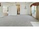 Open living space with neutral carpet, chandelier and archway at 4048 St Ives Blvd, Spring Hill, FL 34609
