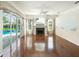 Bright living room with hardwood floors, fireplace, and sliding glass doors to the pool area at 4048 St Ives Blvd, Spring Hill, FL 34609