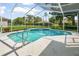 The screened-in pool has a ladder and spa for relaxing on a nice day at 4048 St Ives Blvd, Spring Hill, FL 34609