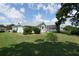 The backyard features a well-maintained lawn and screened in pool enclosure at 4048 St Ives Blvd, Spring Hill, FL 34609