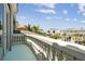 Balcony view overlooking palm trees, neighborhood homes, and a glimpse of the water in the distance at 4348 Harborpointe Dr, Port Richey, FL 34668