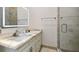 Modern bathroom featuring an illuminated mirror, granite countertop, updated fixtures, and a glass-enclosed shower at 4348 Harborpointe Dr, Port Richey, FL 34668