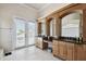 Spacious bathroom with double sinks, vanity, mirrors, and doors to a balcony at 4348 Harborpointe Dr, Port Richey, FL 34668
