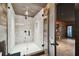 This modern bathroom features a glass-enclosed shower with wood paneling and tile for a luxurious spa experience at 4348 Harborpointe Dr, Port Richey, FL 34668
