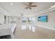 Bright and spacious bedroom featuring marble floors and water views from multiple windows and doors at 4348 Harborpointe Dr, Port Richey, FL 34668