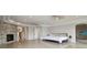 Spacious bedroom with marble floors, tray ceilings, stone fireplace, and water views at 4348 Harborpointe Dr, Port Richey, FL 34668